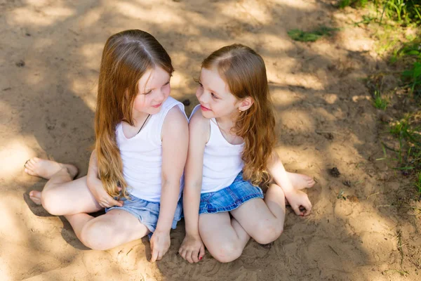 Dos niñas amigas abrazándose en el bosque —  Fotos de Stock