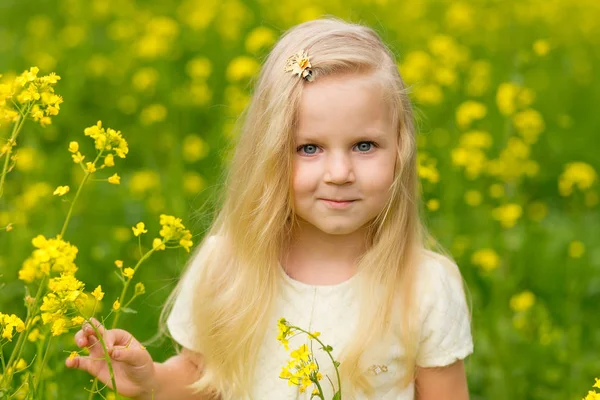 Mooi meisje met een kroon op haar hoofd spelen in een flo — Stockfoto