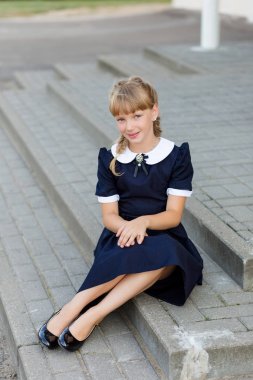 Portrait of a beautiful girl in a school uniform before class at clipart