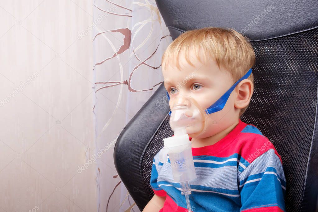 Boy making inhalation with a nebulizer