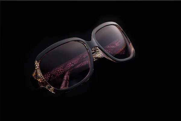 Sunglasses on black reflective background Stock Photo