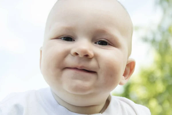 Tevreden en gelukkig weinig jongen portret. Kleine baby lacht in licht — Stockfoto