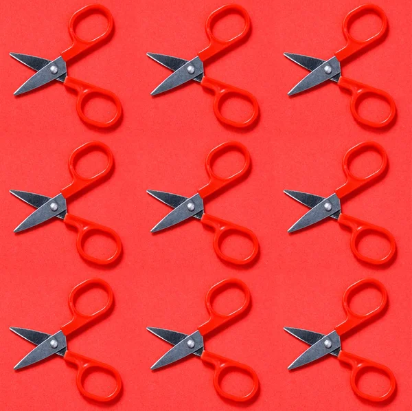 Red scissors on red background in pop art style