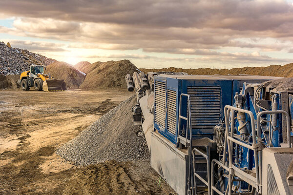 Stone crusher in a stone extraction mine. Heavy machinery to process stone
