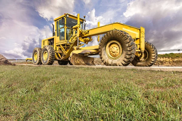 Excavator to level and smooth the land in the construction of a road