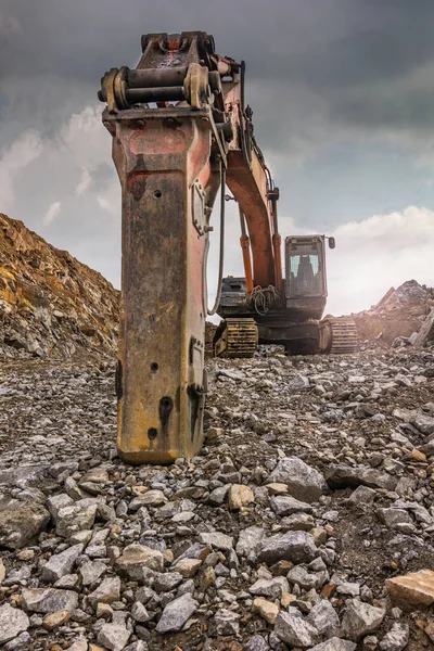 Earth moving by a bulldozer in the construction of a road in Spain. Hydraulic hammer for backhoe