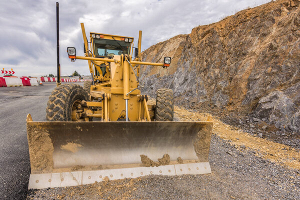 Grader working on gravel leveling