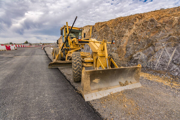 Excavator in the road construction works