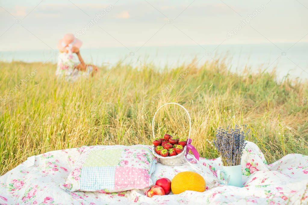 Picnic on the cliff near the sea among the green grass