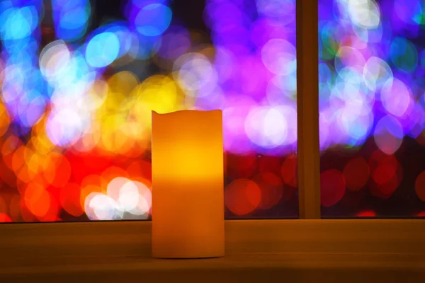 Burning Candle Window Background Glittering Colorful Lights Out Focus Multicolored — Stock Photo, Image
