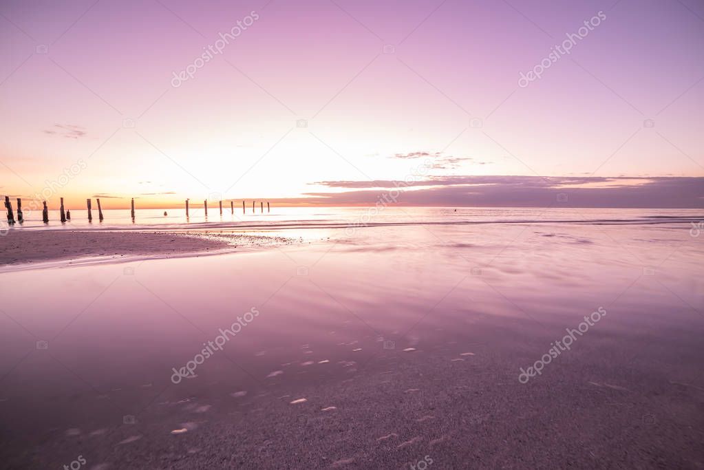 Sunset on the Bay.  A crimson in the water. Long exposure. Lovely relaxing atmosphere of the evening. USA. Florida. Gulf of Mexico.