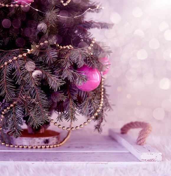 New Year\'s Christmas scenery. Christmas tree branches with toys and sparkling lights.