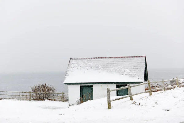 Little house by the ocean on a winter snowy day. Portland USA. Maine