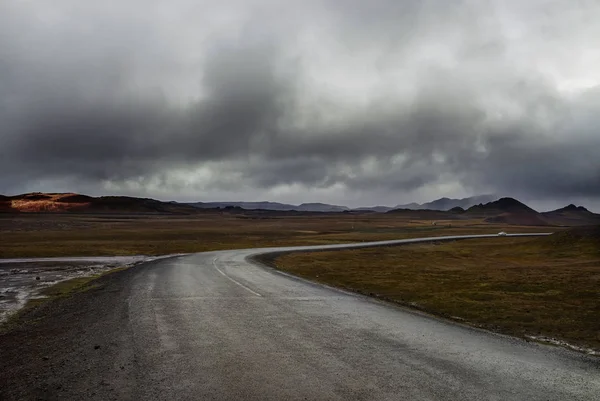 Dramatic sky and weather and a runaway road.  Iceland.