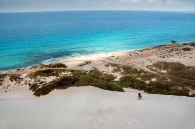 Top view from a sand dune on the coast of the Indian Ocean. exotic beautiful deserted island with a baked dune and views of the emerald coast. Socotra Yemen.