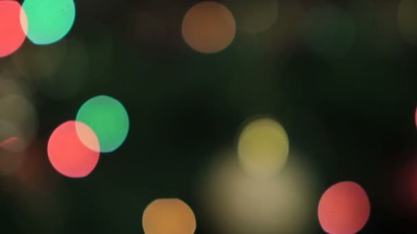 Blurred colorful bokeh circles of christmas lights — ストック動画