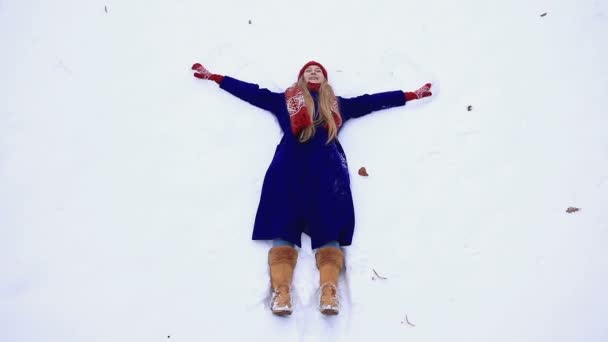 Mujer feliz haciendo ángel de nieve — Vídeo de stock