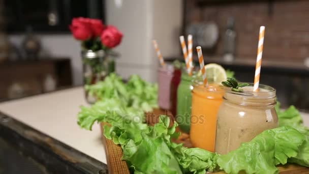 Tray with assortment of smoothies in jars — Stock Video