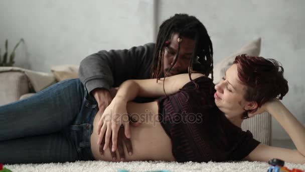 Young mixed race couple in love expecting a baby. — Stock Video