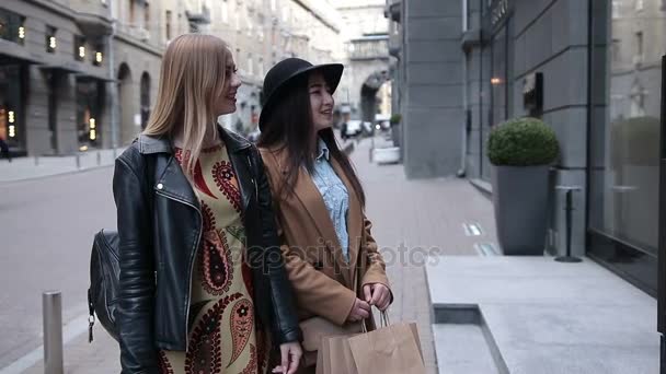 Two excited elegant women looking in shop window — Stock Video