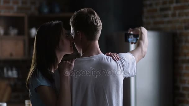 Couple making self-portrait on smart phone at home — Stock Video