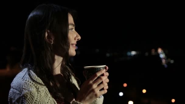 Lovely woman enjoying hot drink in night city — Stock Video