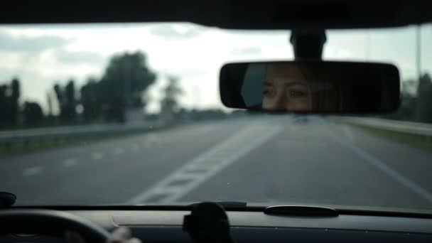 Weerspiegeling van mooie vrouw in de auto in de achteruitkijkspiegel — Stockvideo