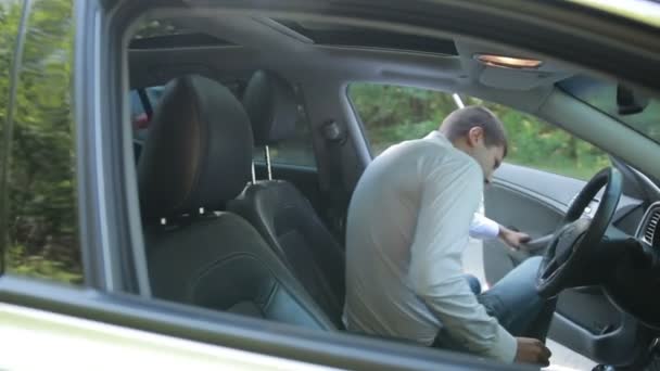 Businessman in car fastening seatbelt — Stock Video