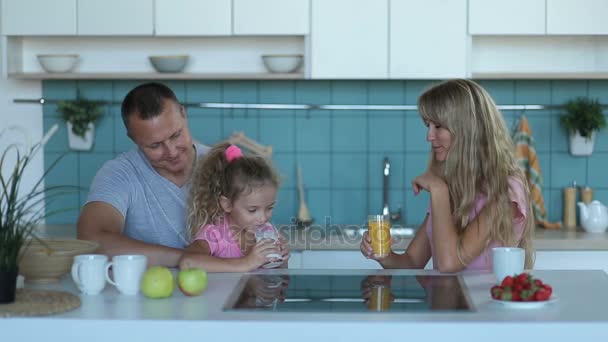 Cute girl drinking milk in kitchen in the morning — Stock Video