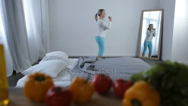 Beautiful woman exercising at home — Stock Video