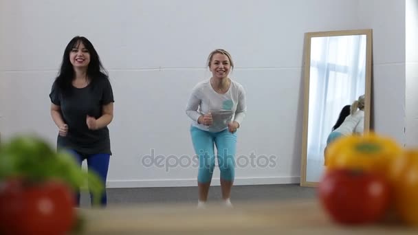 Two sporty women doing fitness exercise at home — Stock Video