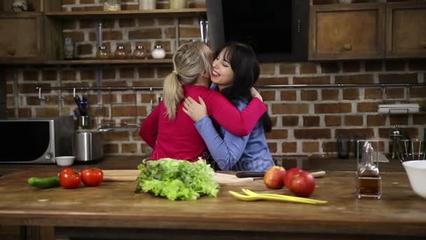 Two sisters unpacking shopping bag in the kitchen — Stock Video