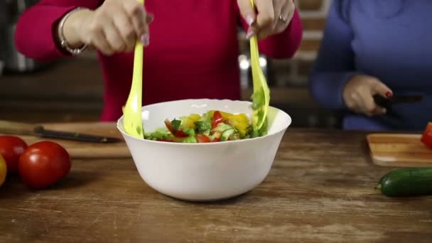 Женщина размешивает миску свежего овощного салата — стоковое видео