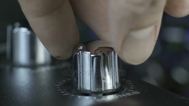 Male fingers turning silver audio interface knob — Stock Video