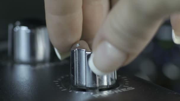 Female fingers turning silver audio interface knob — Stock Video
