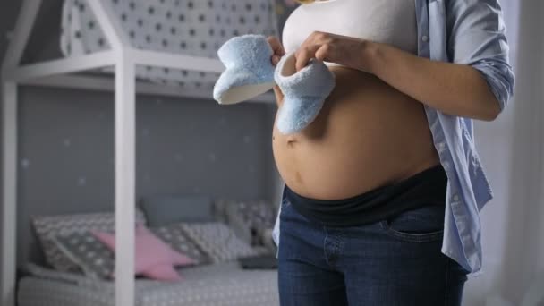 Gravid mamma leker med söt Babyskor — Stockvideo