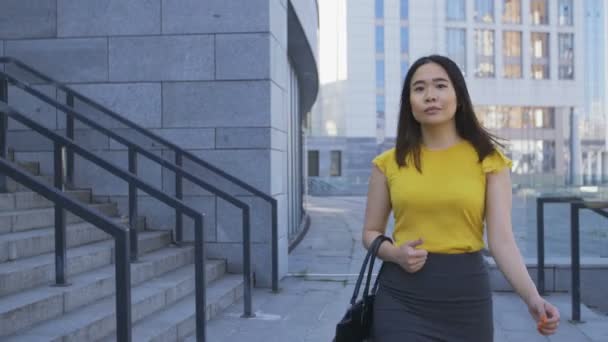 Азиатская деловая леди, идущая на работу утром — стоковое видео