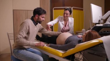 Couple expecting baby on examination in hospital