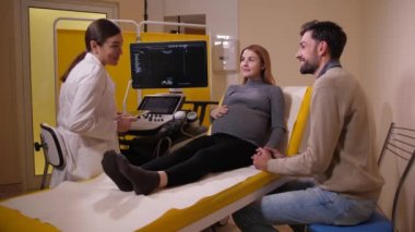 Doctor talking to future parents at consultation