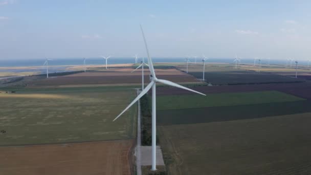 Aerial view of windfarm among agricultural fields — Stock Video