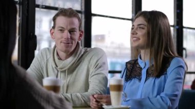 Close up laughing mates talking in coffee shop