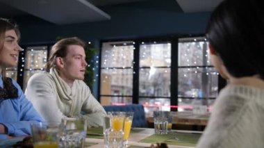 Şehir restoranında şaka yapan bir grup arkadaş.