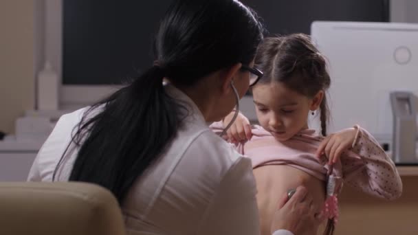 Nervous little girl during heartbeat examination — Stock Video