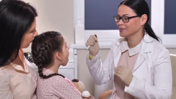 Pediatrician examining child patients throat — Stock Video