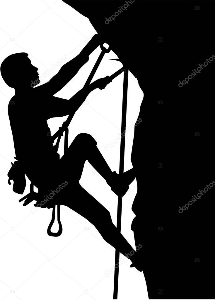 Climber silhouette in ropes an a rock