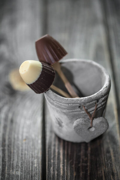 chocolates on a stick in  bucket