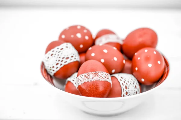 Red Easter eggs on a white plate — Stock Photo, Image