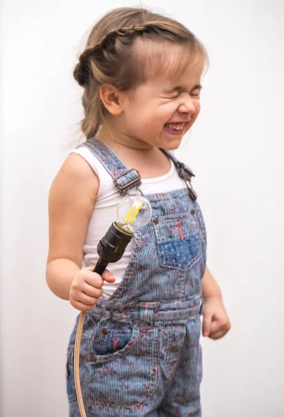 Little cute girl with light bulb in hand — Stock Photo, Image