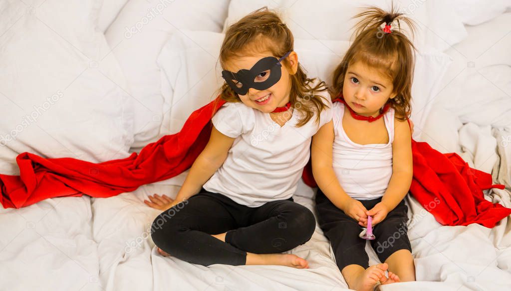 two little girls playing super hero