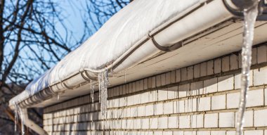 ice icicles on the roofs of houses clipart